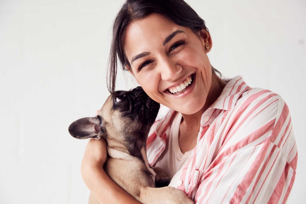 Women holding frenchie puppy