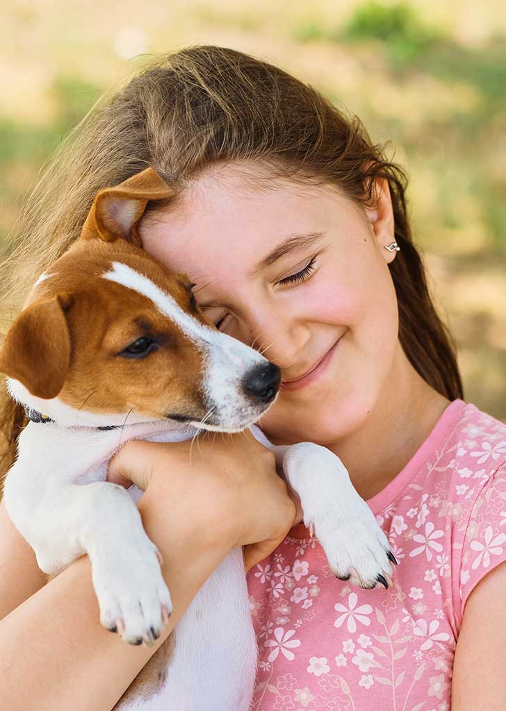 A picture of a cute kid holding a cute puppy