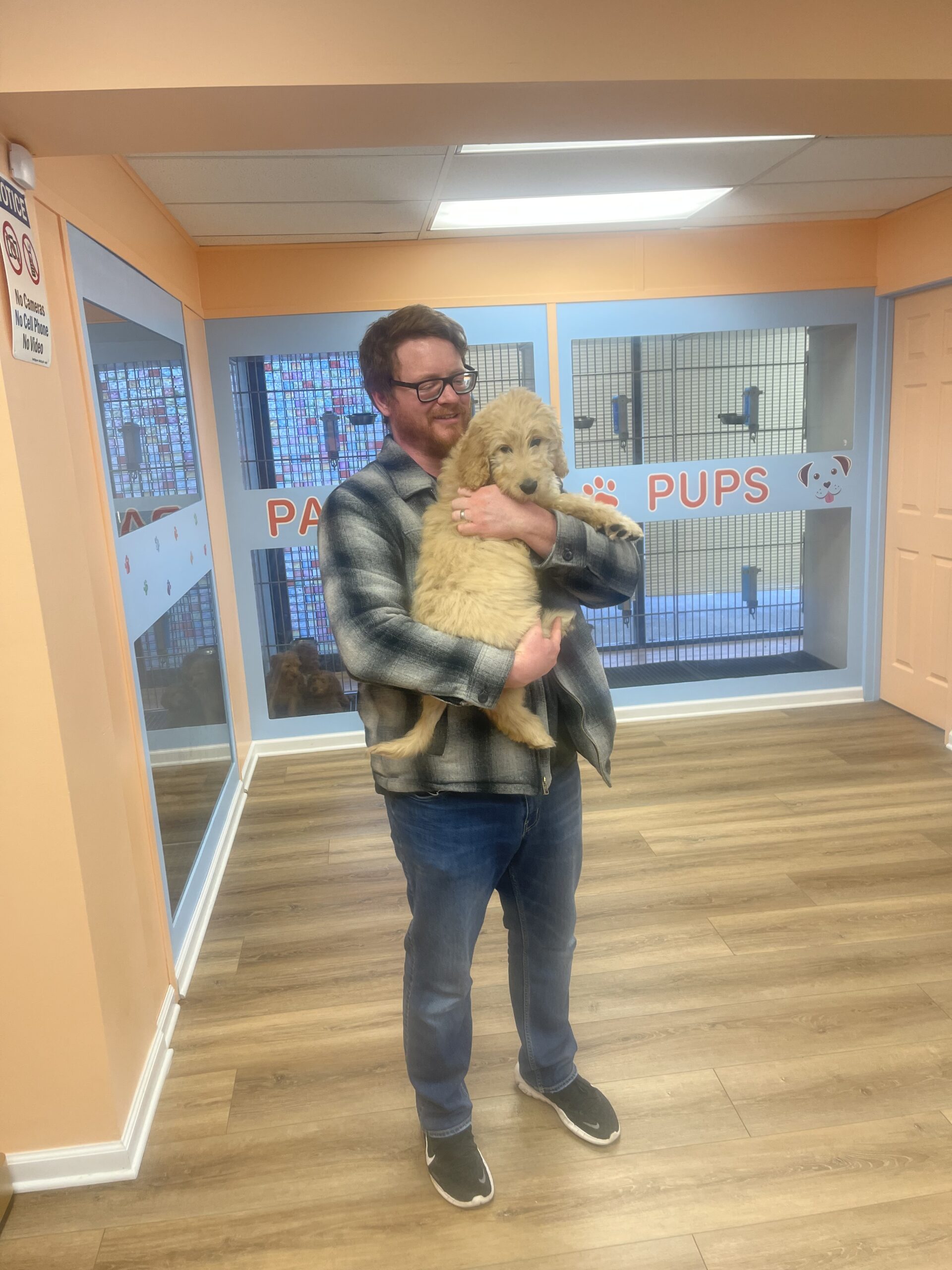 a man holding a dog and smiling