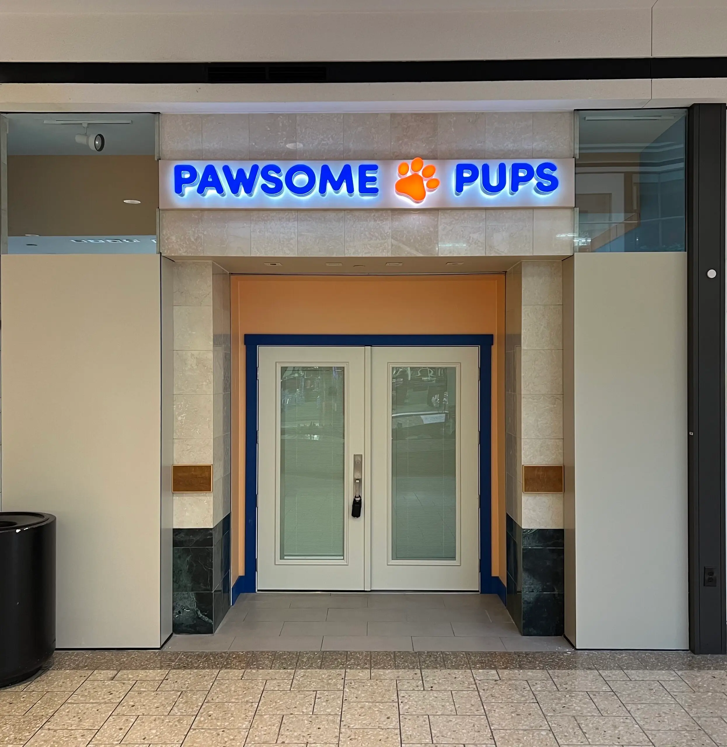 Pawsome pups store entrance with doors.